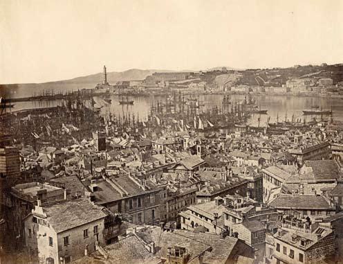 Genova, panorama della città da sudest con nello sfondo il porto