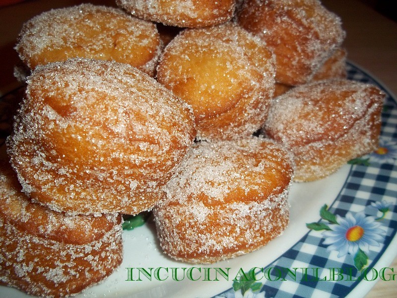 FRITTELLE MIGNON 1 kg di farina per dolci 500 ml di latte 100 g di burro 100 g di zucchero 2 uova 50 g di lievito di birra 1 pizzico di sale 1 bustina di vanillina 2 arance olio per friggere ( semi