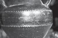 linee parallele a cordicella. 700-675. a.c. 63 - Tazza monoansata su alto piede in Bucchero nero lucidato a cera.