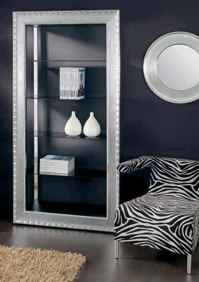 Free-standing bookcase with 2 led spotlights structure made of tubular steel chrome finished or black varnished. Solid wood frame 12 cm wide gold or silver leaves hand decorated.