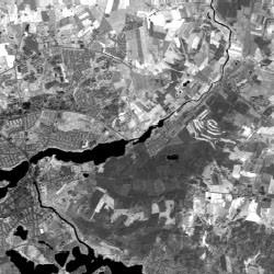 LANDSAT channel4 0.76-0.90 micrometres, corresponding to parts of the near infrared. Water gives the least reflectance (black) and green fields give the greatest reflection (white).