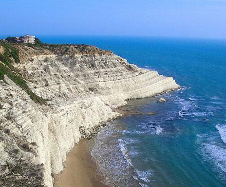 Una falesia viva costruita da uno sperone di marna bianca prominente sul mare, le cui falde degradanti a strato conferiscono un aspetto molto suggestivo. Proseguimento per Agrigento (km.