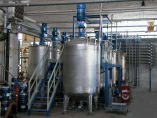 Pilot plant for the production of powder premixed materials including the injection of liquids under pressure and various additives.