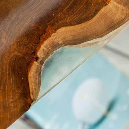 Natural teak coated in transparent resin which sneaks in the teak s holes, round the edges, removes imperfections.