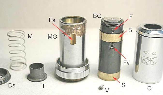 Fig. 2519 Anche qui, nulla di nuovo. Tolta la corta vite V, si sfila il barilotto generale (BG) dalla montatura generale (MG). La vite V s impegna nel foro Fv e scorre nella fessura Fs.