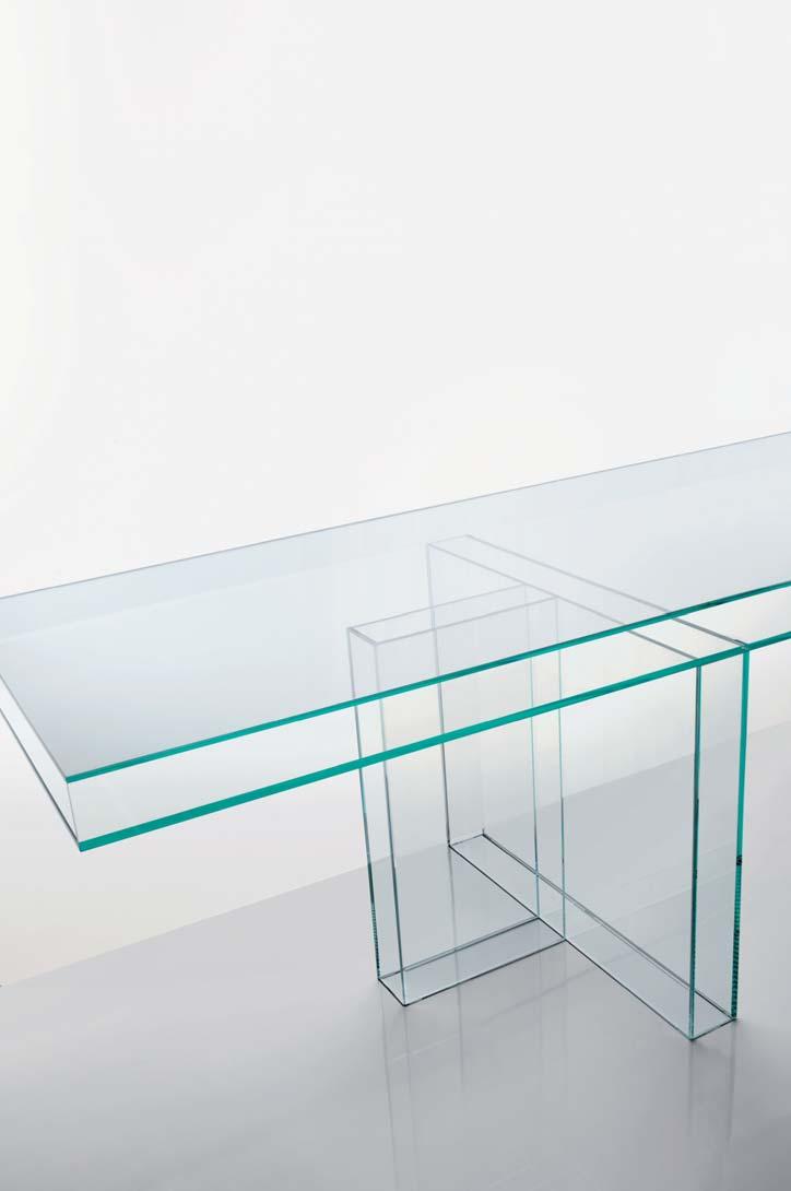 26-27 Table constructed from boxed volumes in 10 mm thick transparent extra light tempered glass, obtained thanks to complex gluing manufacturing The top is supported by two T shaped bases and it has