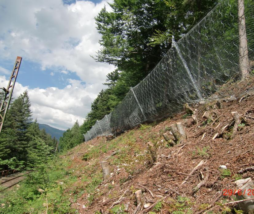 Line 1 of the RXE-500 rockfall barrier fully installed - visible support rope separation