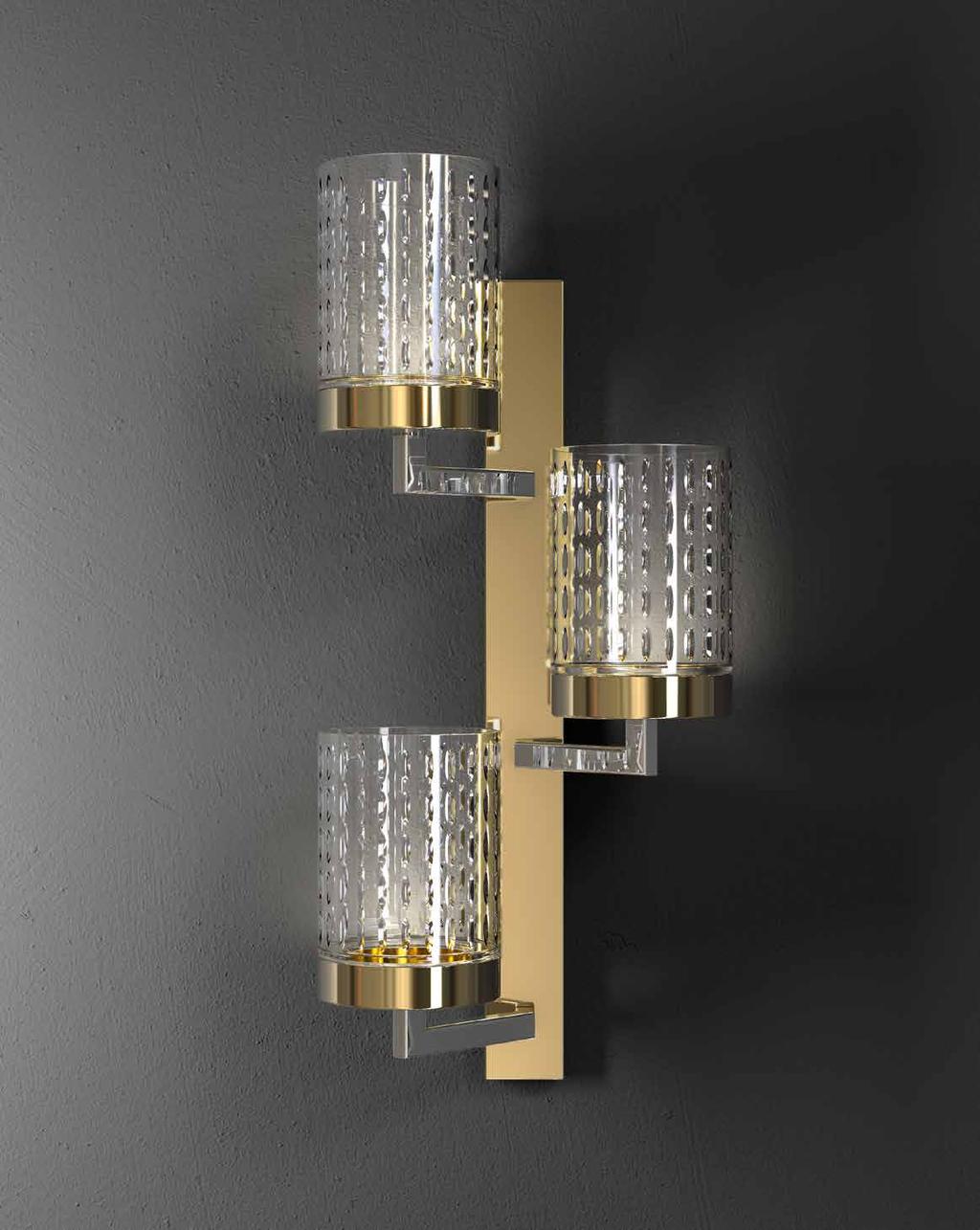 : Wall sconce in chrome and light gold metal structure finish with carved crystal diffusers.