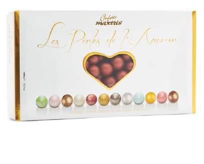 les perles etè les perles hiver MAXTRIS LES PERLES ETÈ GOLD Nocciola tostata avvolta da un duplice strato di cioccolato bianco e cioccolato fondente, ricoperto da un