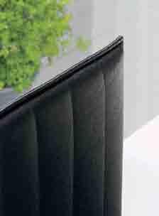 headboard with a black leatherette cover with linear vertical seams.