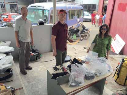 Fig. 3 - Jeff Genrich (Caltech, a sinistra) e Mike Fend (UNAVCO) posano, assieme a Ritu Vayda (a destra), di fronte ai pezzi di ricambio all interno del laboratorio della Toyota Nepal: Vayda e suo