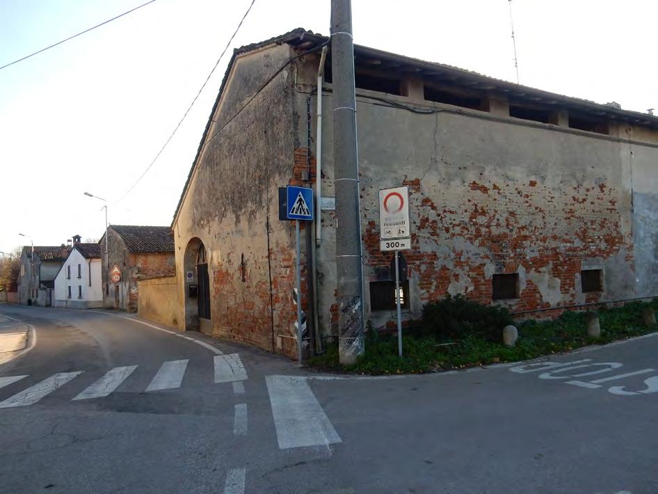 Muro continuo articolato su più livelli: da muro di recinzione diventa muro perimetrale delle abitazioni e della cascina senza discontinuità.