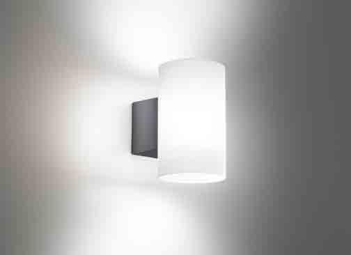 A wall lamp with a matt white or dark grey painted aluminium fixture, a satin white finish polycarbonate diffuser and a LED light source.