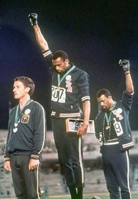 Tommie Smith (center) and John Carlos raise
