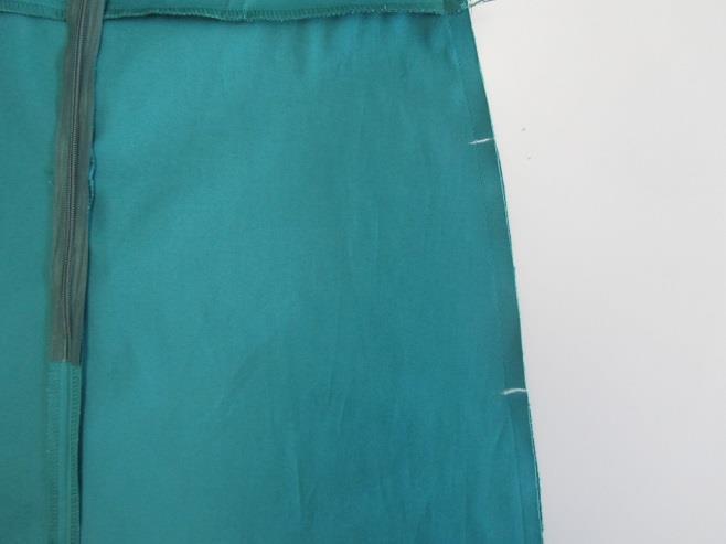 Tasche inserite: chiudi le cuciture laterali dell'abito dal giromanica alla marca dello spacco, quindi ferma l'estremità della cucitura.