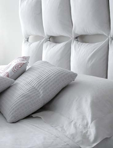 The elegant simplicity of all white headboard cushions.