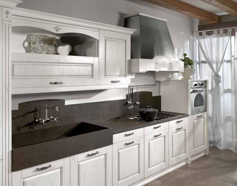 A STRONG CHARACTER characterizes this kitchen, which combines pickled white doors with a beautiful 3cm thick top with a sink and a back panel in black.