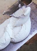 A base di cemento bianco, calce, sabbia silicea, fibre.