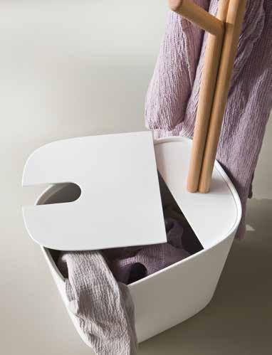Glacier White Corian laundry basket with a small wooden tree which cab be used as a
