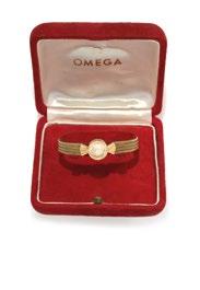 A RED GOLD, RUBY, PEARL AND DIAMOND BRACELET CONCEALING A HAND WOUND LADY S WRISTWATCH.