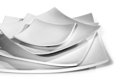 A collection of plates with the particularity of the edges that curve up.