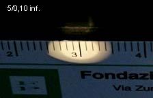 Fig. 16 a/b/c Obbiettivo CF 5/0,10. Apertometro piano (sopra); lettura: l = 8,3. NA = 0,103. NB: il valore di d è stato portato a 40 mm. Apertometro cilindrico (a destra in alto); l = 2,4. NA = 0,104.