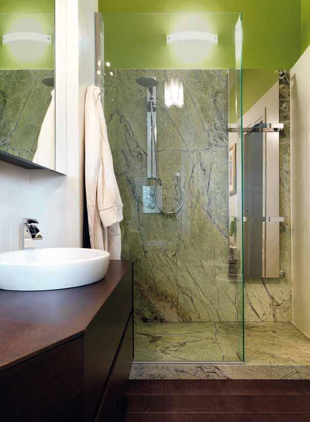 Nel bagno in primo piano la doccia interamente rivestita in Marmo Forest verde.