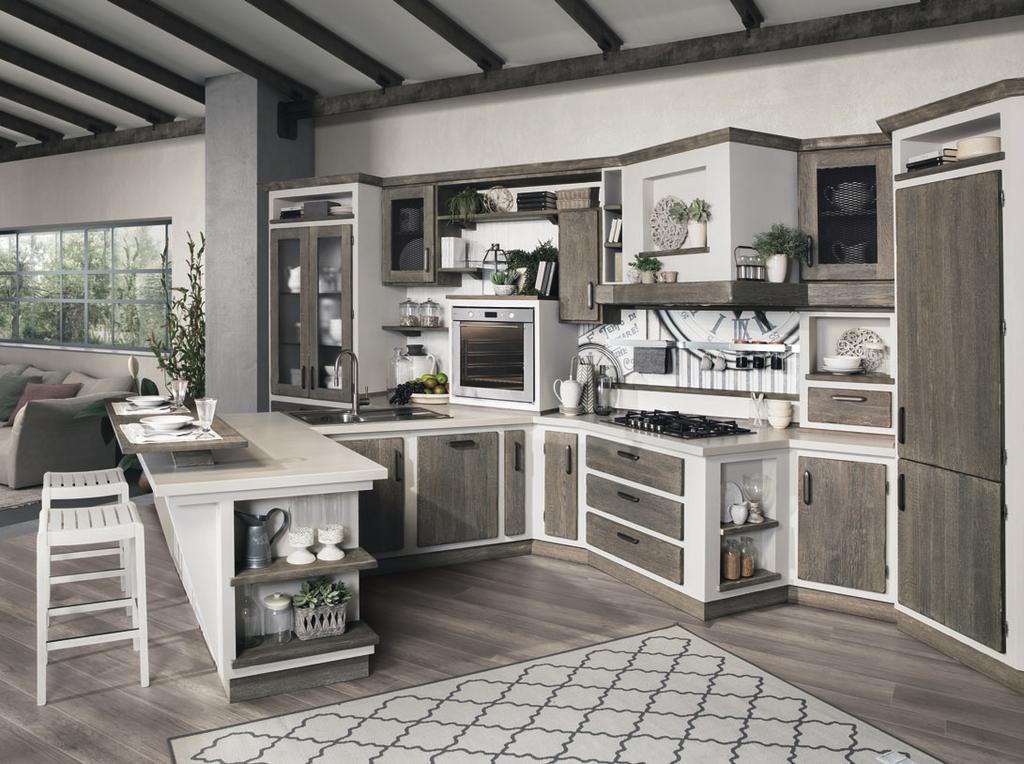 Una cucina dalla linea tradizionale che diventa contemporanea grazie alle ante con griglia, alle maniglie moderne e al Living con libreria che si integra al corpo centrale per offrire una soluzione