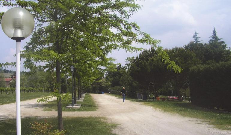 PERCEZIONE 4 di 6 sulla strada con fondo in ghiaia, un accesso laterale pedonale alla villa, un piazzale che si