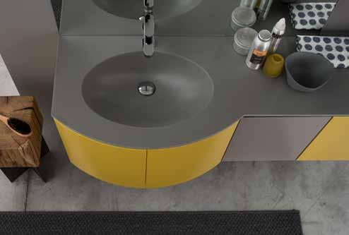 The curved, coloured base unit with a built-in washbasin has a straight base that